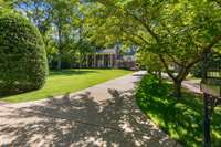 The expansive front lawn and stately columns of this Southern classic architecture create an impressive presence from the street.