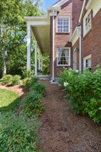 The landscaping is full of well manicured plants and shrubbery.