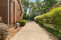 The driveway with a gate at the back corner of the house.