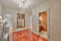 Upon entering the home you are greeted by a luxurious foyer with chandelier and a designed medallion floor.