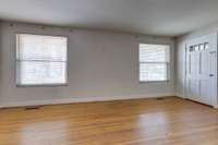 Living room with abundant natural light and hardwood flooring