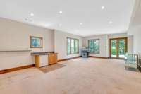 This walkout basement bonus room has doors to the exterior and a wet bar.