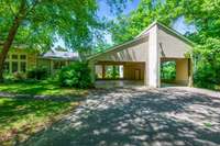 The attached carport has room for two cars AND a tour bus or RV.