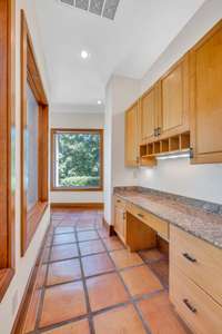 This hallway is off of the kitchen and shows the built-in desk.