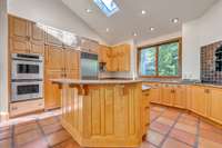 This view of the kitchen highlights the vaulted ceiling.