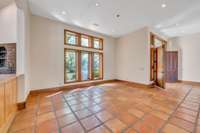 The open concept dining room sets between the entryway and the kitchen and has twelve foot ceilings.