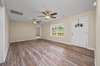 Just inside the front door you are greeted by this living room space complete with laminate hardwood floors, double ceiling fans and a double window overlooking the front yard area.