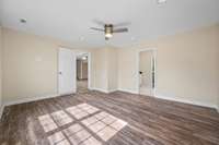 Another view of the primary bedroom and how it connects to the living room and ensuite bath.