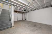 Garage area and staircase up to the utility room.