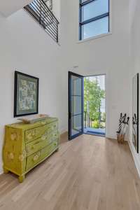 Beautiful soaring ceiling and custom pendant lighting in the entry.  Homes has been freshly painted throughout.