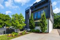 Lush, mature landscaping and beautiful exterior modern architecture.