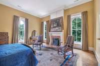 The second primary bedroom which is located on the second level features a fireplace with marble-clad surround.