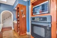 The kitchen has multiple storage opportunities - both open and behind doors.