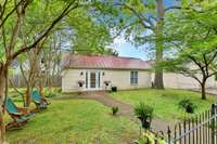The rear guest house is charming in it's own right.  Notice the standing seam roof which fits the property perfectly.