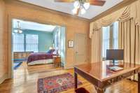 Currently, this space is being utilized as a home office.  The grass cloth covering the walls adds an upscale touch to the space.
