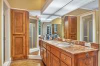 There are two full baths upstairs.  This one is located in the western primary wing and features double vanities, a shower and separate tub.