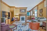In addition to the parlors, there's a separate den which also has a fireplace.