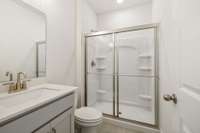 First floor full bath with easy access shower and white quartz counters