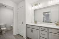 Secondary hall bath with dual sinks & linen closet