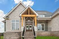 LOVE the rich colors and this front entrance to the home! *Green grass was edited for MLS purposes - this is an active construction site & landscaping has yet to be completed.