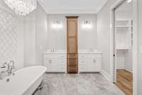 A side view of this splendid primary bathroom. A few highlights include handmade custom cabinets with a linen tower in the middle, quartz countertops, chrome hardware throughout & mirrors to come. This bathroom is so calming.