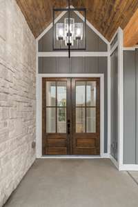 Walking into these beautiful solid wooden doors with Baldwin hardware and stained tongue and groove wooden ceiling is everyone's dream with a new home.