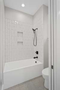 An additional photo of the tiled shower.