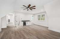 The bonus room upstairs also features a drink cooler with a few cabinets for extra storage. The two doorways lead to additional rooms that was originally attic space but was opened up for extra space & storage.