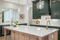 A closer view of the custom built white oak island and the gorgeous countertops.