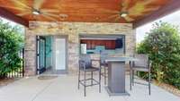 Covered patio off the pool house.  Garage -like door installed to completely close up and secure the pool house when not in use.