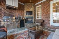 Built in grill, fireplace and tv on covered porch