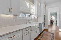 Newly renovated backsplash and countertops. Farm sink and double ovens leading into the butlers pantry.