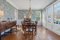 Open dining room accented with Serene and Lily wallpaper that is so inviting and happy!