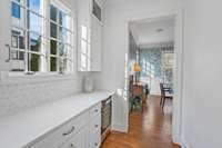 Butlers pantry with wine fridge. Newly installed backsplash with gold insets and architectural design