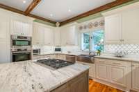 Granite countertops and marble backsplash. Wolf and Miele appliances.