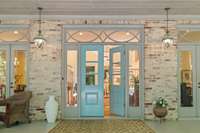 Home features antique mortar-washed brick and gorgeous double French doors.