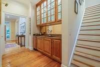 Timeless copper wet bar. Lighted custom cabinetry to hold all your barware. Scotsman icemaker.  Stairs pictured to the right is the second set of stairs leading to the upper level.