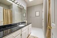 Shower/tub combo with linen closet.