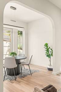 A stunning arched design invites you into a light-filled dining space, perfect for seamless indoor/outdoor entertaining.