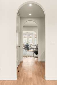 Two sets of double arches guide you from the foyer into the main living area, with one passing by a large coat closet and the other passing by the wet bar and powder room.