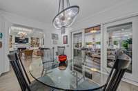 Breakfast nook opens to the sunroom with metal sliding doors.