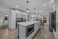 A Chef's style kitchen with beautiful stone Island and an abundance of cabinets!