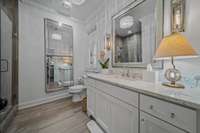 Guest Bathroom features a granite countertops and tiled floors.