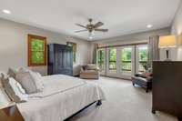 Primary bedroom with atrium doors leading out to the 2nd floor balcony