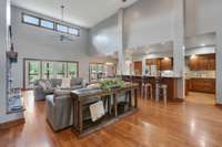 Livingroom with soaring ceilings, lots of natural light & warm fireplace.