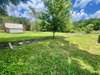 View behind the home and property - Property stake to the left in photo shows subject property lot line.