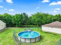 Fenced in side yard and above ground pool