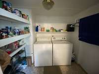 Separate laundry room with pantry and additional storage.