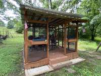 Custom outdoor grill/bbq screened area with power. What a great place to sit while watching the kids play in the yard. Or perfect spot to hang out with friends. Only thing missing is the swimming pool.