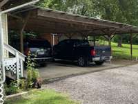 3 car carport. 2 with concrete floor and the other great for lawn mower or that boat you can’t wait to put in at the local boat dock down the street